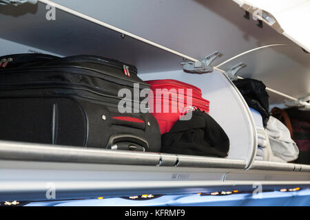 Overhead passenger locker lockers / compartment / compartments for stowing passengers bags cabin luggage; BA / British Airways Portugal flight. (76) Stock Photo