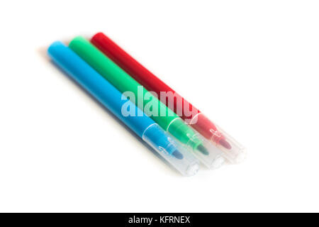 Three Colored markers in a Row. Close up shot on White Background Stock Photo