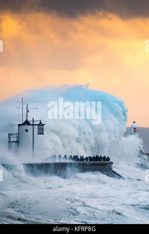 Waves crash against the harbour wall during Storm Brian at Porthcawl, South Wales. The Met Office have issued a yellow weather warning for wind and ha Stock Photo