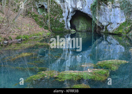 Springhead and clear, turquoise water of Krupaja river running out from the cave, Krupajsko vrelo, Serbia Stock Photo