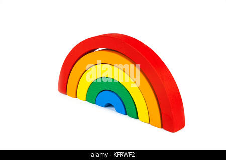 A wooden toy of seven different-colored arcs in the form of a rainbow on a white isolated background, the arcs are folded like a rainbow Stock Photo