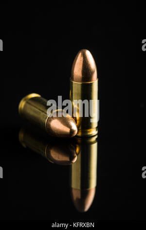 9mm pistol bullets on black table. Stock Photo