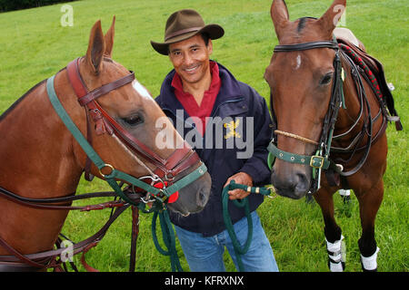 Martin Ephson with his polo ponies 'Vampiro' (white spot on head and red disc on bridle) and 'Jungle' at his home in Wiltshire. Stock Photo