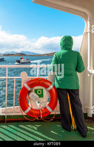 Female tourist aboard the Caledonian MacBrayne ferry boat to the Isle of Mull from Oban, Argyll and Bute, Inner Hebrides, Scotland, UK Stock Photo