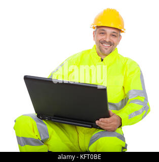 Portrait of worker in safety jacket working on laptop. Isolated on white Stock Photo