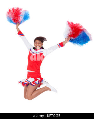 Smiling beautiful cheerleader with pompoms. Isolated on white Stock Photo