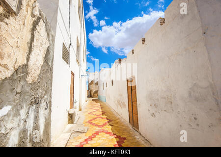 Cityscape with narrow street in Medina of Kairouan. Tunisia, North Africa Stock Photo