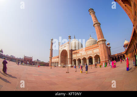 DELHI, INDIA - SEPTEMBER 27, 2017: Unidentified people walking in front of a beautiful Jama Masjid temple, this is the largest muslim mosque in India. Delhi, India, fish eye effect Stock Photo