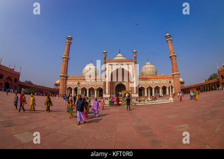 DELHI, INDIA - SEPTEMBER 27, 2017: Unidentified people walking in front of a beautiful Jama Masjid temple, this is the largest muslim mosque in India. Delhi, India, fish eye effect Stock Photo
