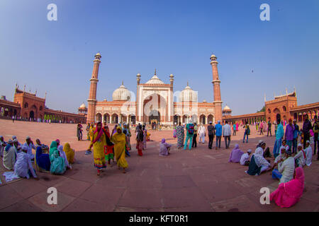 DELHI, INDIA - SEPTEMBER 27, 2017: Crowd of people walking in front of a beautiful Jama Masjid temple, this is the largest muslim mosque in India. Delhi, India, fish eye effect Stock Photo