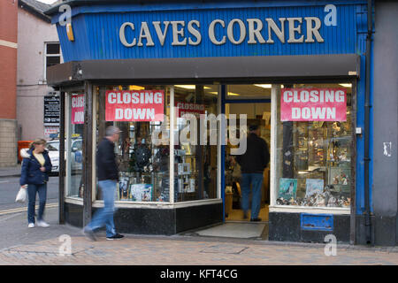 Out of focus figures passing Retail units To Let, UK independent shop signs.  Closed, Closing down, Shuttered shops, businesses in decline.   The Malaise affecting British Seaside resorts. Blackpool, Lancashire, UK Stock Photo
