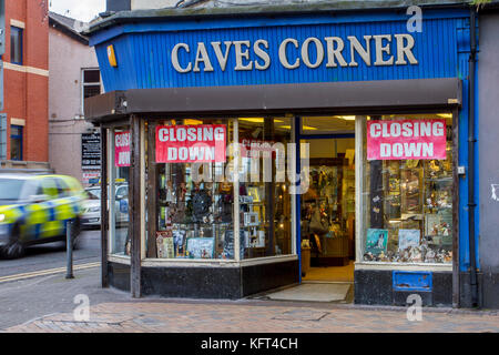 Out of focus figures passing Retail units To Let, UK independent shop signs.  Closed, Closing down, Shuttered shops, businesses in decline.   The Malaise affecting British Seaside resorts. Blackpool, Lancashire, UK Stock Photo