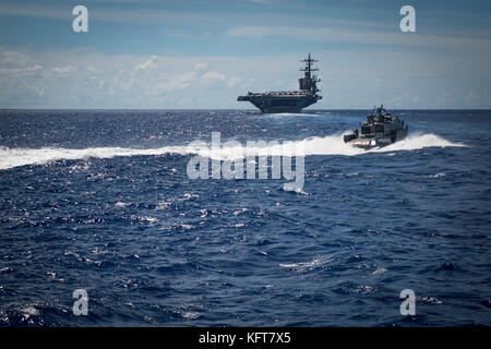 Sailors assigned to Coastal Riverine Squadron (CRS) 2, aboard a MK VI patrol boat, provide high value asset protection for the aircraft carrier Stock Photo