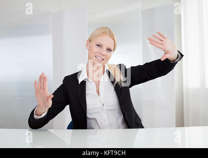 Beautiful businesswoman touching the screen with her finger Stock Photo