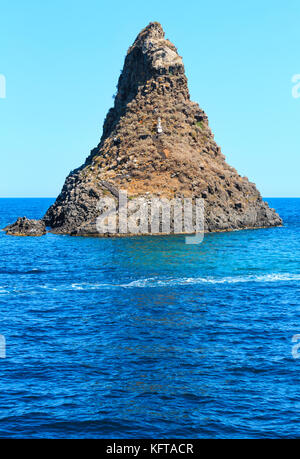 Cyclopean Coast and the Islands of the Cyclops on Aci Trezza town (Italy, Sicily,10 km north of Catania). Known as Isoles Dei Ciclopi Faraglioni. Stock Photo