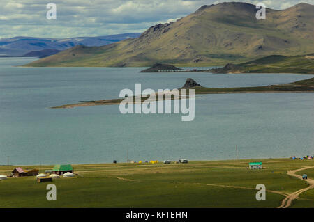 Camping tents at a lake in mongolian grassland natural landscape Stock Photo