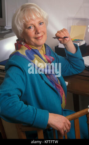 attractive mature executive woman sitting in office Stock Photo