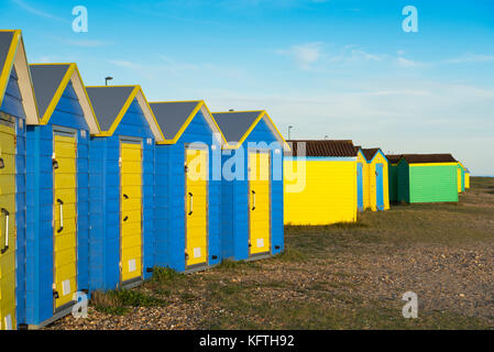 Groups of colourful beach huts on the beach at Littlehampton on an autumn afternoon Stock Photo