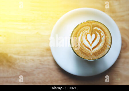 heart drawing on latte art coffee on wood table background Stock Photo