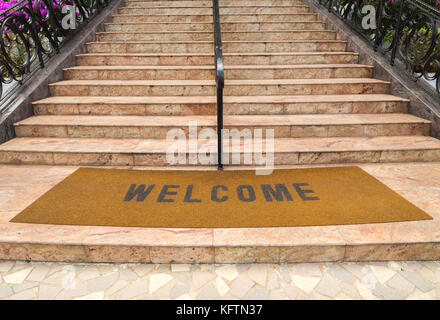 welcome plastic red carpet in front of the marble staircase at the hotel Stock Photo