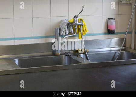 interior of an industrial kitchen with stainless steel sink Stock Photo