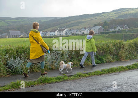 family walking dog, Ballintoy, Co. Antrim, Northern Ireland Stock Photo