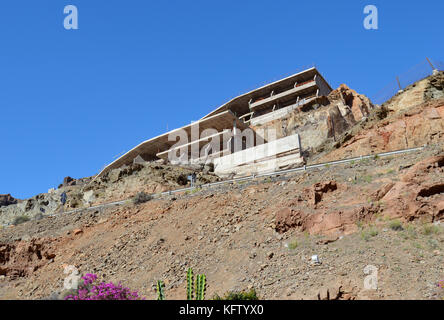 Looking up at an unfinished hotel at Taurito Gran Canaria Spain. Stock Photo