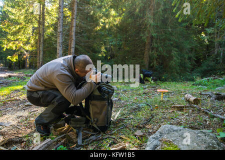 Professional nature photographer with camera and big backpack Stock Photo