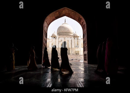 Argra, Taj Mahal, India - March 3 2012: Women in traditional saris passing arch in Taj Mahal in Agra, Uttar Pradesh, India Stock Photo