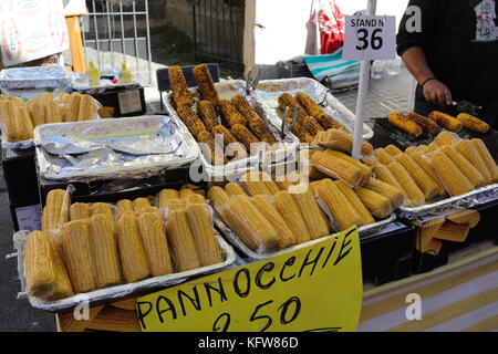 MANZIANA, LAZIO, ITALY - OCTOBER 14, 2017: Vendor grilling sweet corn on the street at the chestnut festival. Stock Photo