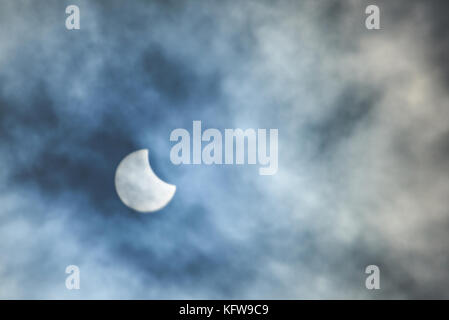 oon over sun in eclipse on blue cloudy background Stock Photo