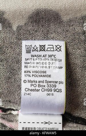 wash care symbols and instructions on label in woman's top from Marks and Spencer 83% viscose 17% polyamide Stock Photo