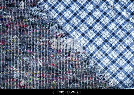 Background of checkered fabric lying on piece of quilted felt Stock Photo