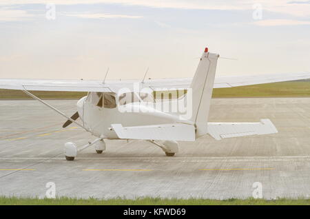 White Small Aircraft on the Runway Rear View Stock Photo