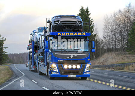 SALO, FINLAND – DECEMBER 11, 2015: Volvo FM car transporter hauls Range Rover vehicles. The luxury SUV Range Rover, produced by the British Land Rover Stock Photo