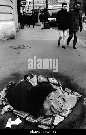 Woman and baby sleeping rough on the streets of Paris, France. Stock Photo
