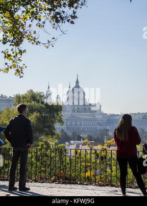 Two people looking at the Cathedral of la Almudena. Madrid, Spain Stock Photo