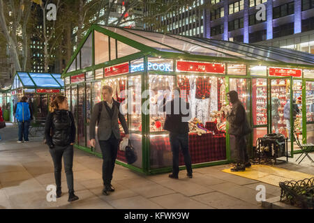 Shoppers browse the Bryant Park Holiday Market in New York on Tuesday, October 31, 2017. Diverse merchants sell unique holiday gifts and foods to the park visitors. The market will be open until January 2, 2018. (© Richard B. Levine) Stock Photo