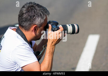 Kiev, Ukraine - September 20, 2017: Street photographer taking pictures with professional digital camera Stock Photo