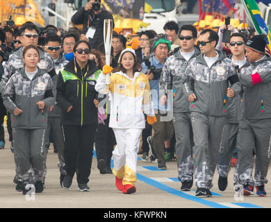 Incheon, South Korea. 1st Nov, 2017. You Young, Nov 1, 2017 : South Korean figure skater You Young (C) who is the first torch bearer runs with an Olympic torch at the Olympic Torch Relay on the Incheon Bridge in Incheon, west of Seoul, South Korea. The Olympic flame arrived in Incheon, South Korea on Wednesday and it is going to be passed across the country during a 100-day tour until the opening ceremony of the 2018 PyeongChang Winter Olympics which will be held for 17 days from February 9 - 25, 2018. Credit: Lee Jae-Won/AFLO/Alamy Live News Stock Photo