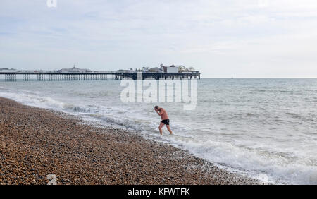 Brighton, UK. 1st November, 2017. A swimmer emerges from the sea off Brighton beach in unusually warm Autumn weather today Credit: Simon Dack/Alamy Live News Stock Photo