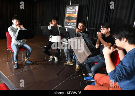 Trossingen, Germany. 1st Nov, 2017. A group of music students of the Kings College Old Boys Association from Hong Kong warm up with their harmonicas in Trossingen, Germany, 1 November 2017. It is the first day of the World Harmonica Festival 2017. Credit: Felix Kästle/dpa/Alamy Live News Stock Photo