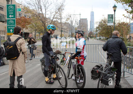 New York, USA. 01st Nov, 2017. Cyclists have a conversation after a terrorist act next to a barrier near the crime scene in New York, US, 01 November 2017. A 29-year-old man sped along the cycle path and walkway with a rented light truck. At least eight people died, eleven injured. Credit: Christina Horsten/dpa/Alamy Live News Stock Photo