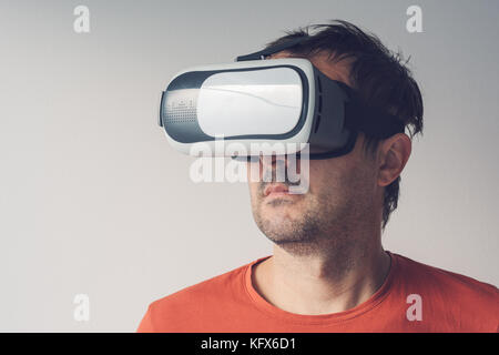 Man with virtual reality goggles. Adult male person enjoying VR. Stock Photo