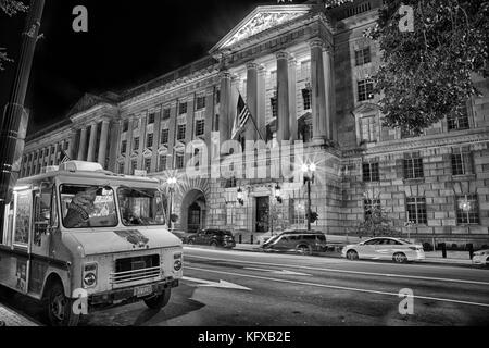 September 12, 2017, Washington, DC, USA: The US Department of Commerce  building, at night with a food truck parked in front. Symbol of big versus sma Stock Photo