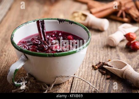 Homemade cranberry sauce in rustic mug, preparation Thanksgiving dinner Stock Photo