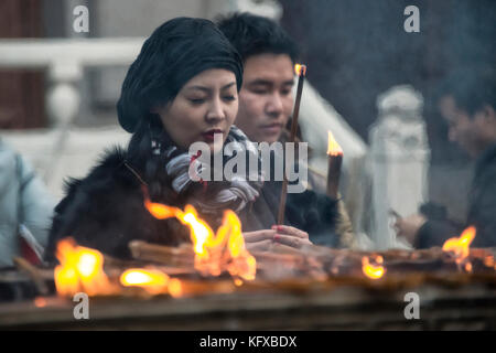 Woman performing daily traditional ritual, Shanghai Stock Photo