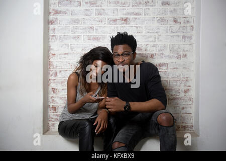 Couple looking at a cellphone Stock Photo