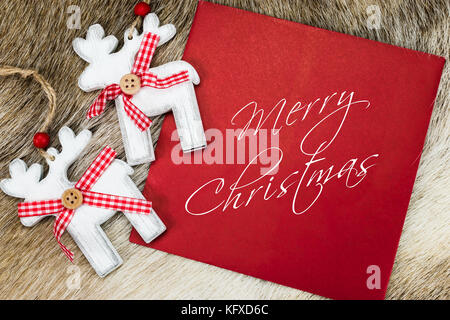 Merry Christmas card with handwritten text on red envelope. Stock Photo