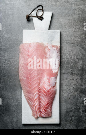 Raw Red fish fillets on marble cutting board , top view Stock Photo
